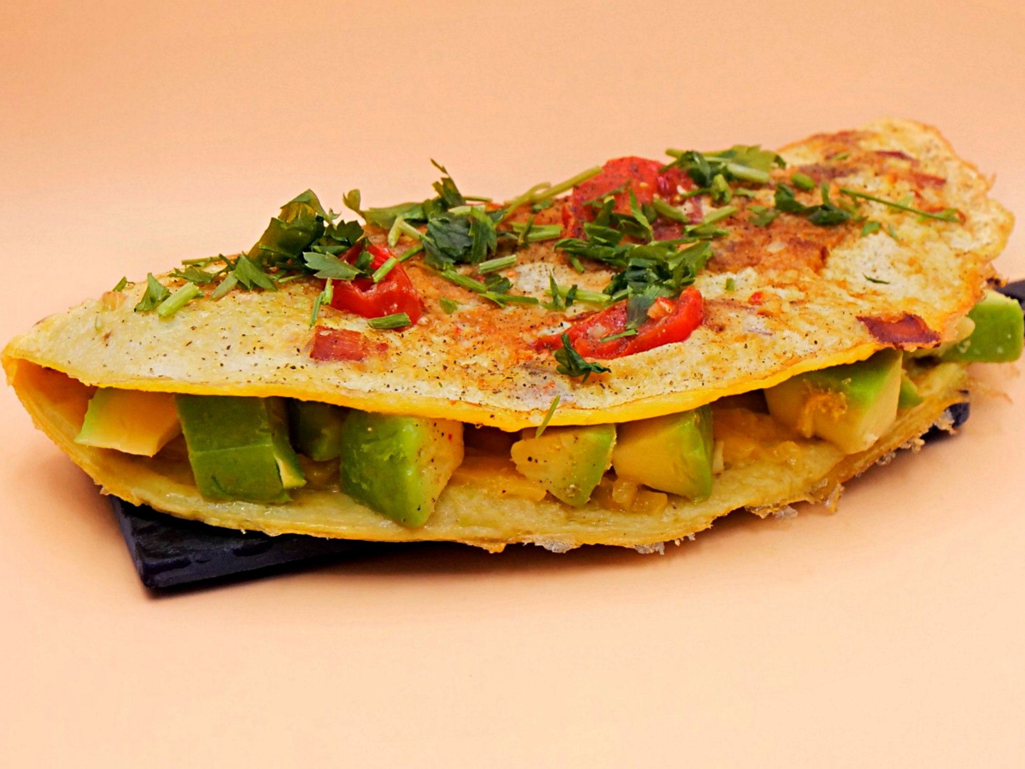 Serowy omlet z boczkiem, awokado i pomidorkami przepis